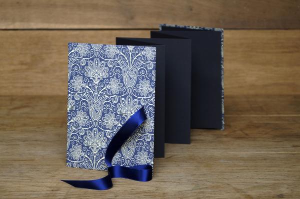 Mini photo book for 14 photos, blue and white, small graphic stars, yellow satin ribbon